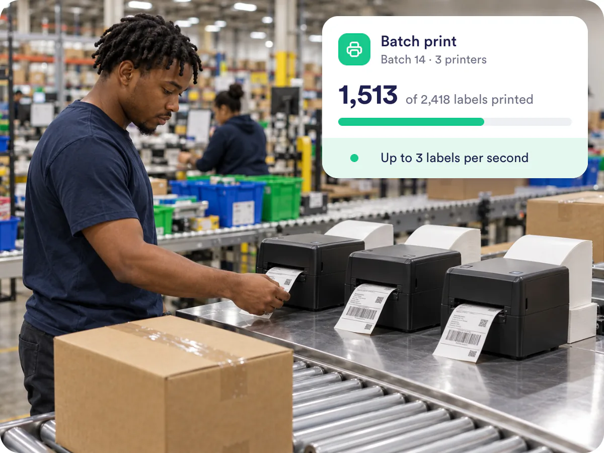 High-volume shipping software printing labels as packages move down a warehouse conveyor